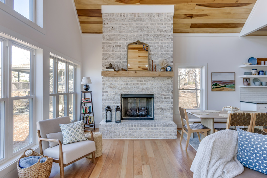 Main living room with vaulted wood ceiling and lake views